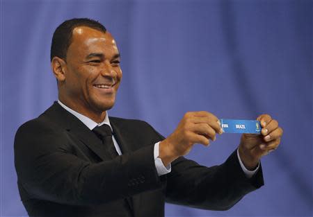 Former Brazilian soccer player Cafu holds the slip showing "Brazil' during the draw for the 2014 World Cup at the Costa do Sauipe resort in Sao Joao da Mata, Bahia state, December 6, 2013. REUTERS/Paulo Whitaker