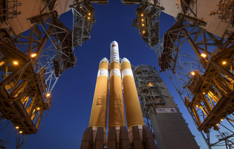 The Mobile Service Tower is rolled back to reveal the United Launch Alliance Delta IV Heavy rocket with the Parker Solar Probe onboard, Saturday, Aug. 11, 2018, Launch Complex 37 at Cape Canaveral Air Force Station in Fla. A last-minute technical problem Saturday delayed NASA's unprecedented flight to the sun. Rocket maker United Launch Alliance said it would try again Sunday, provided the helium-pressure issue can be resolved quickly. Once on its way, the Parker probe will venture closer to our star than any other spacecraft. (Bill Ingalls/NASA via AP)