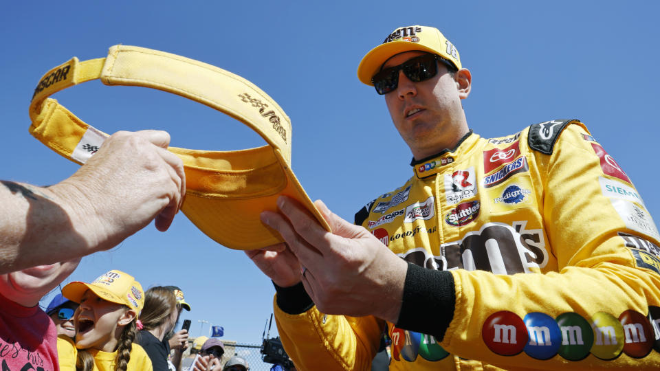 Kyle Busch gives autographs before a NASCAR Cup Series auto race at Kansas Speedway in Kansas City, Kan., Sunday, Sept. 11, 2022. (AP Photo/Colin E. Braley)