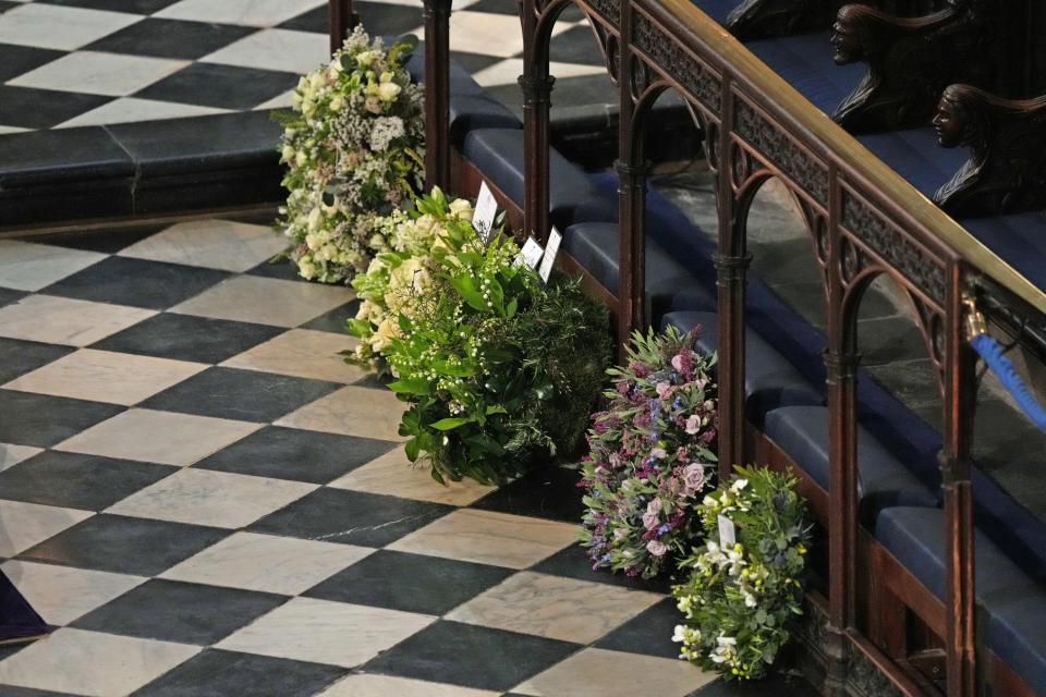 Wreaths from members of the royal family lie against the pews during the funeral. (Photo: WPA Pool via Getty Images)