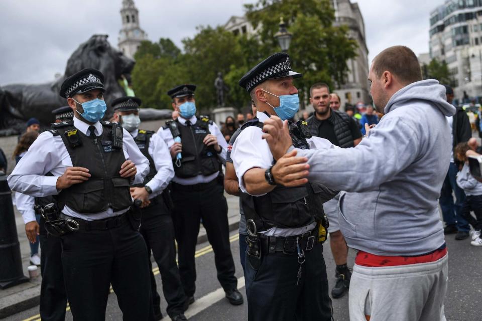 Police confront a protester during Saturday's rally (Getty Images)