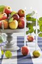 <p>Fill your home with the aromas of autumn with a homemade scent or candle, like this apple-candlestick combo.</p><p><strong><a href="https://www.countryliving.com/diy-crafts/g2009/fall-centerpieces/?slide=30" rel="nofollow noopener" target="_blank" data-ylk="slk:Get the tutorial;elm:context_link;itc:0;sec:content-canvas" class="link ">Get the tutorial</a>.</strong></p>