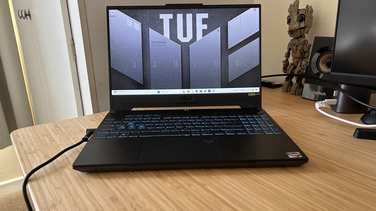  Asus TUF A15 gaming laptop open on a wooden desk. 