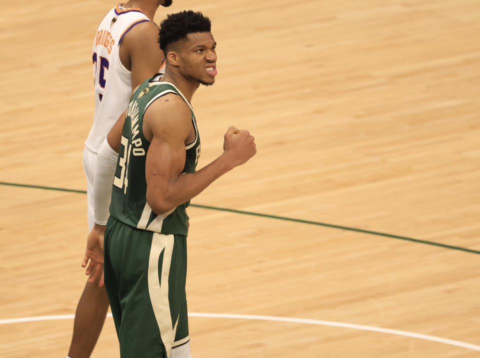 Giannis Antetokounmpo pumps his first in celebration.