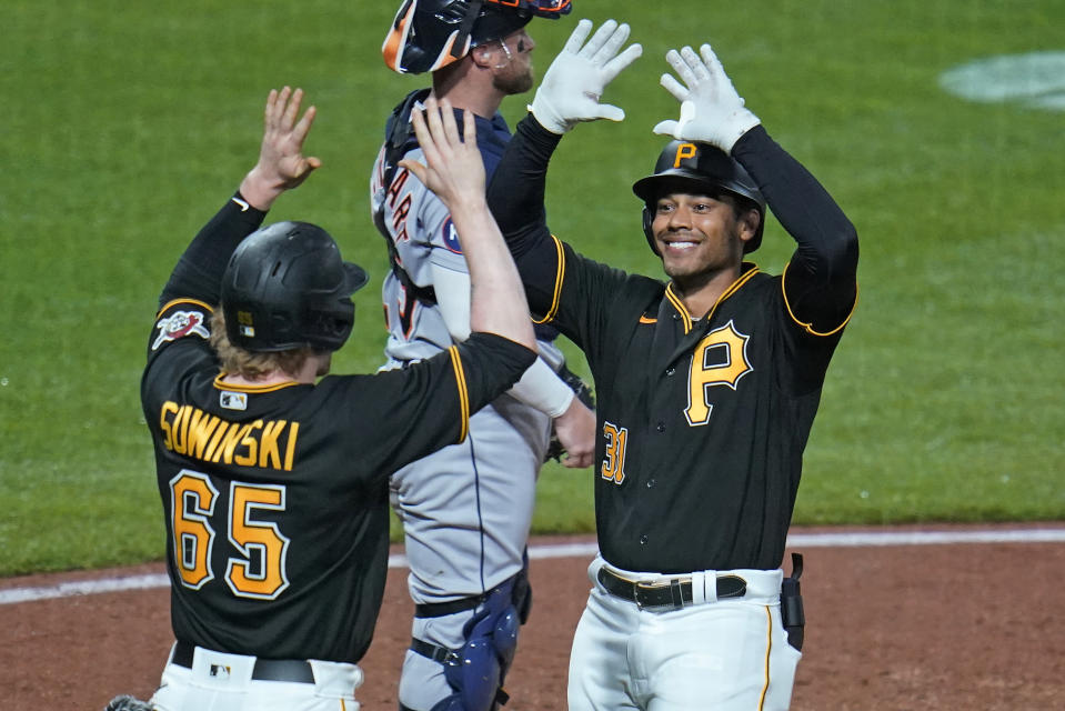 Pittsburgh Pirates' Cal Mitchell, right, is greeted by Jack Suwinski after hitting a two-run home run off Detroit Tigers starting pitcher Tarik Skubal during the fourth inning of a baseball game in Pittsburgh, Tuesday, June 7, 2022. (AP Photo/Gene J. Puskar)