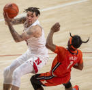 Nebraska guard Teddy Allen (0) knocks over Illinois' Trent Frazier (1) as he drives to the basket during the first half of an NCAA college basketball game on Friday, Feb. 12, 2021, in Lincoln, Neb. (Francis Gardler/Lincoln Journal Star via AP)