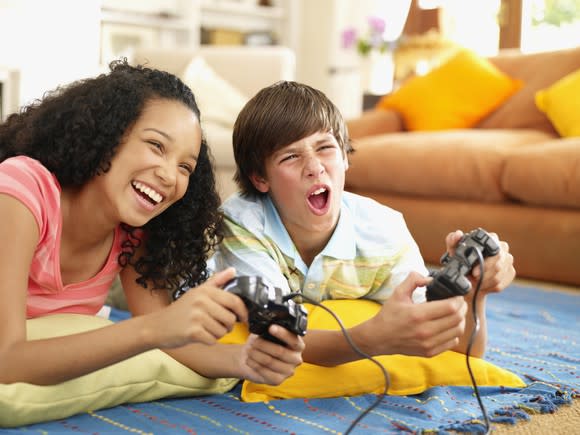 Two children play a console video game.