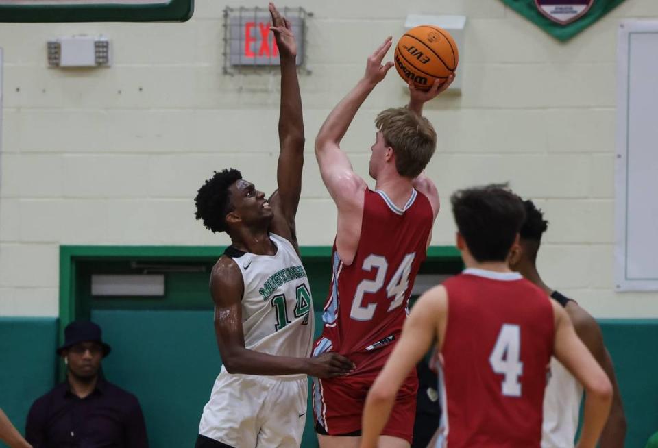 Sir Mohammed, left, attempts to block a shot during a high school game in February. The son of former Kentucky star Nazr Mohammed is a four-star prospect in the class of 2024.