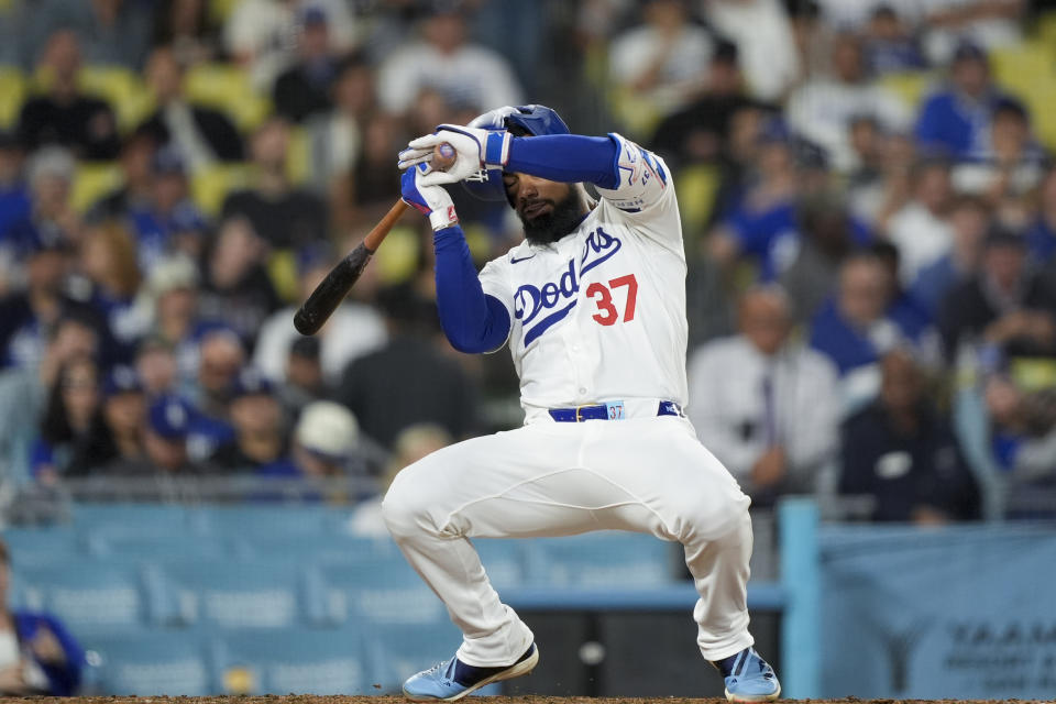 Los Angeles Dodgers' Teoscar Hernandez reacts to a wild pitch from the Texas Rangers during the ninth inning of a baseball game Thursday, June 13, 2024, in Los Angeles. (AP Photo/Ryan Sun)