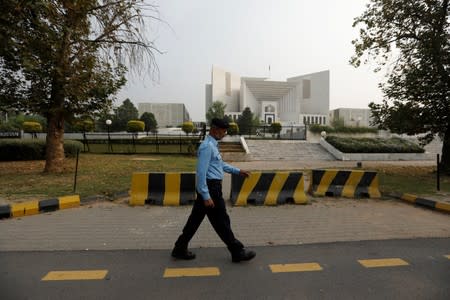 A policeman walks past the Supreme Court building in Islamabad
