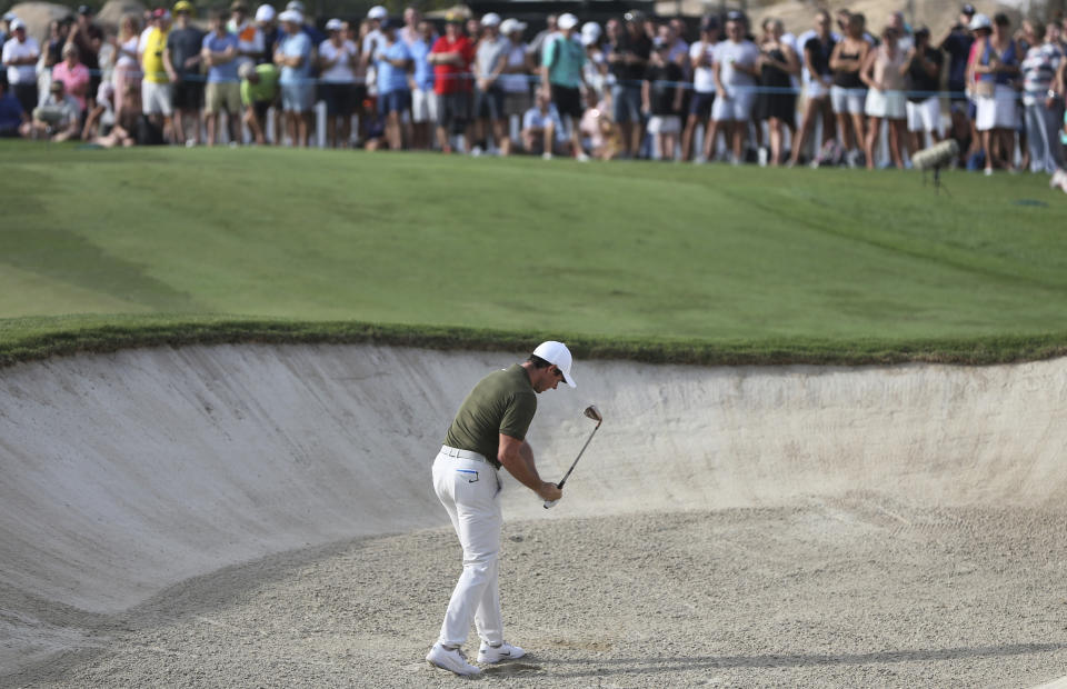 Rory McIlroy from Northern Ireland reacts on the 18th bunker during the second round of the DP World Tour Championship golf tournament in Dubai, United Arab Emirates, Friday, Nov. 16, 2018. (AP Photo/Kamran Jebreili)