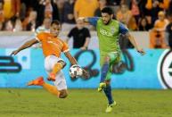 Nov 21, 2017; Houston, TX, USA; Houston Dynamo forward Erick Torres (9) and Seattle Sounders midfielder Lamar Neagle (27) fight for possession during the second half in the first leg of the MLS Western Conference Championship at BBVA Compass Stadium. Thomas B. Shea-USA TODAY Sports