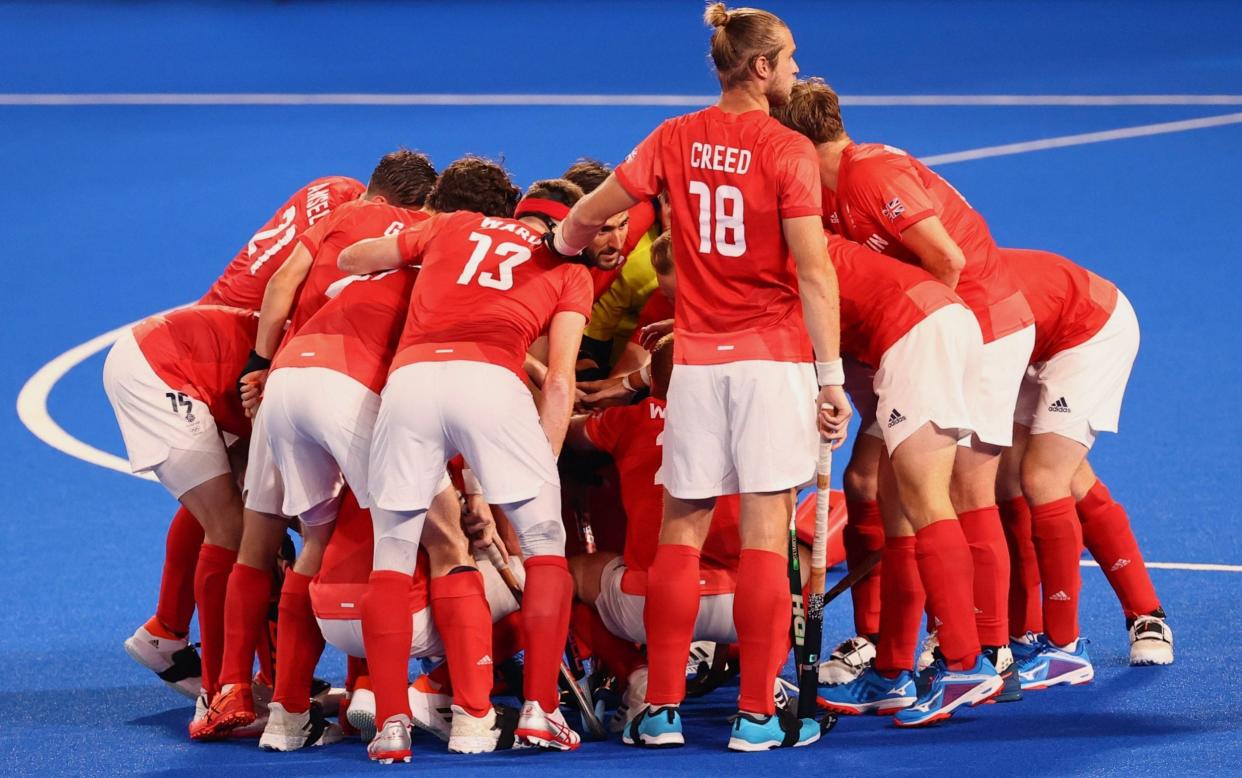 Great Britain huddle up before the start of the match - REUTERS