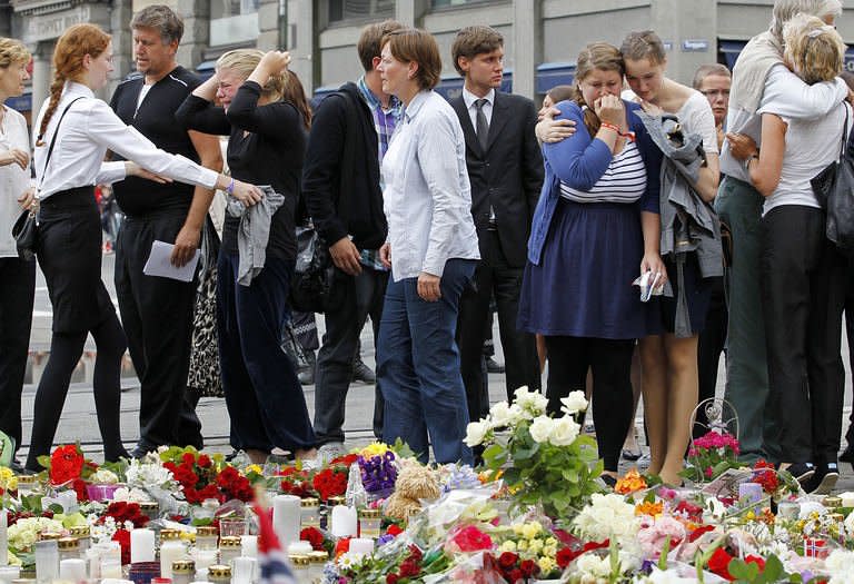 Grieving members of the public embrace after a "mass for sorrow and hope" at Oslo's Cathedral. Suspected Norwegian mass killer Anders Behring Breivik faces justice Monday, after Oslo police defended the hour it took to reach the island where most of his 93 victims died in a hail of bullets