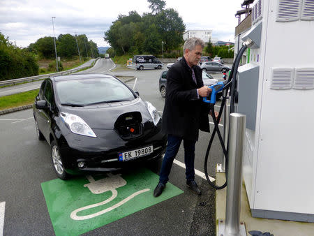 Arne Nordboe recharges his Nissan Leaf electric car in Finnoey, Norway September 8, 2017. REUTERS/Alister Doyle