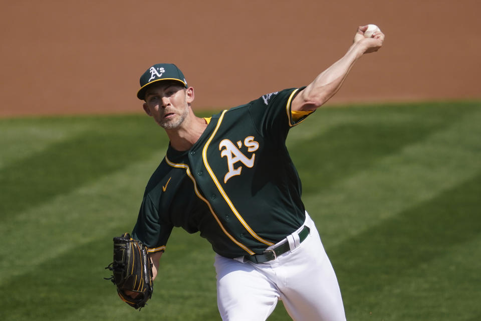 Oakland Athletics' Mike Minor pitches against the San Francisco Giants during the first inning of a baseball game in Oakland, Calif., Sunday, Sept. 20, 2020. (AP Photo/Jeff Chiu)