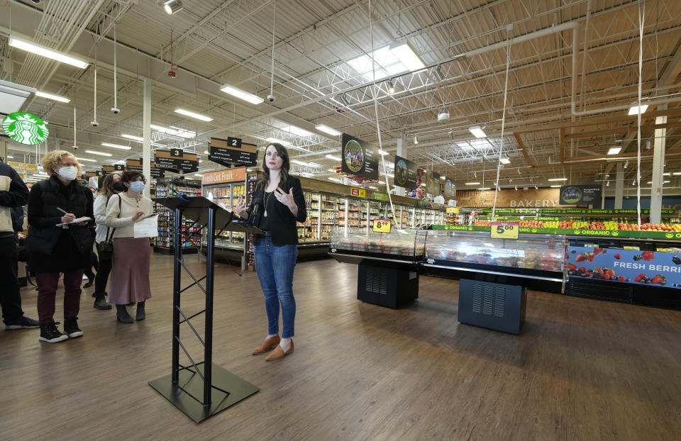 Jessica Trowbridge, center, spokesperson for the King Soopers grocery chain, speaks to media members about the Table Mesa King Soopers during a media tour Tuesday, Feb. 8, 2022, in Boulder, Colo. Ten people were killed inside and outside the store when a gunman opened fire on March 22, 2021. The store reopens with new renovations on Wednesday, Feb. 9. (AP Photo/David Zalubowski)