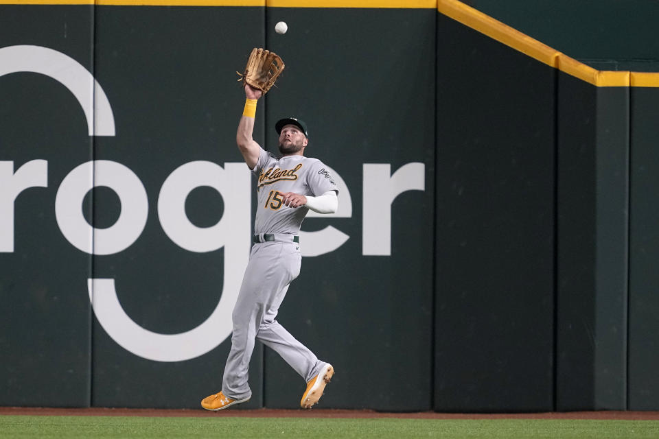 Oakland Athletics right fielder Seth Brown reaches up to catch a fly out by Texas Rangers' Marcus Semien in the fifth inning of a baseball game, Saturday, Sept. 9, 2023, in Arlington, Texas. (AP Photo/Tony Gutierrez)