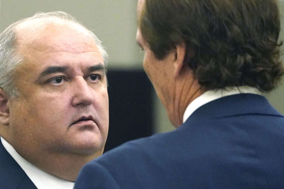 John Davis, former director of the Mississippi Department of Human Services confers with defense attorney Merrida Coxwell, in Jackson, Miss., on Thursday, Sept. 22, 2022. Davis pleaded guilty to new federal charges in a conspiracy to misspend tens of millions of dollars that were intended to help needy families in one of the poorest states in the U.S. — part of the largest public corruption case in the state's history.(AP Photo/Rogelio V. Solis)