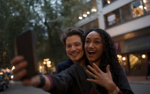 Don't post that engagement selfie too soon... - Credit: Hero Images/Hero Images / Getty Images