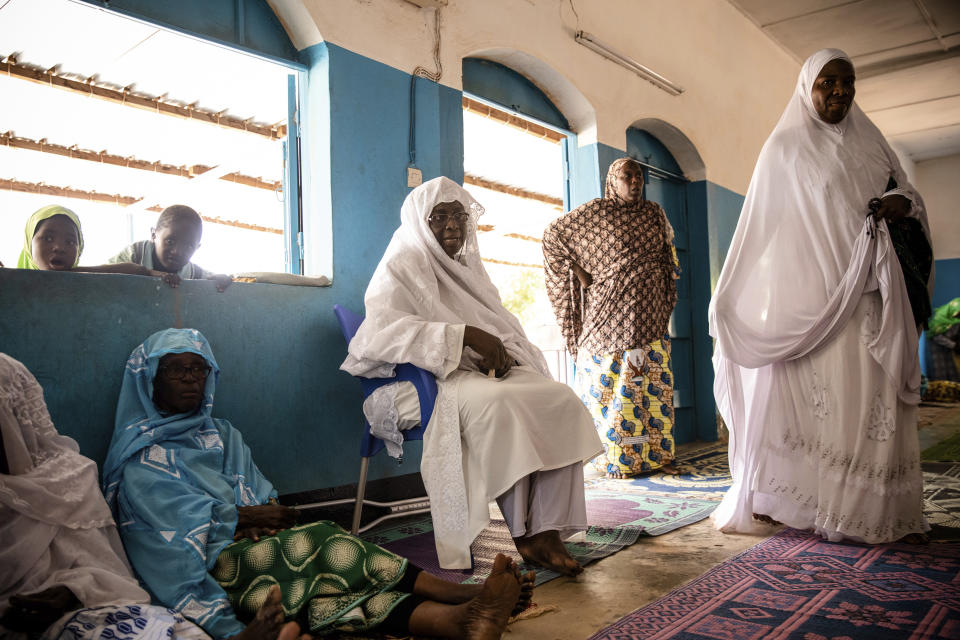 Zenabou Coulibaly Zongo, center consultant and founding member of the Council of Burkinabe Women, distributes soap to the mosque in Ouagadougou, Burkina Faso, Friday, Oct. 29, 2021. Zongo spends her own money making soap and buying hand sanitizer for mosques, markets and health centers. At the start of the pandemic, Zongo, now 63, was hospitalized with bronchial pneumonia. She paid out of pocket for two weeks' worth of oxygen treatments at a private clinic, where she watched others die from respiratory problems. (AP Photo/Sophie Garcia)