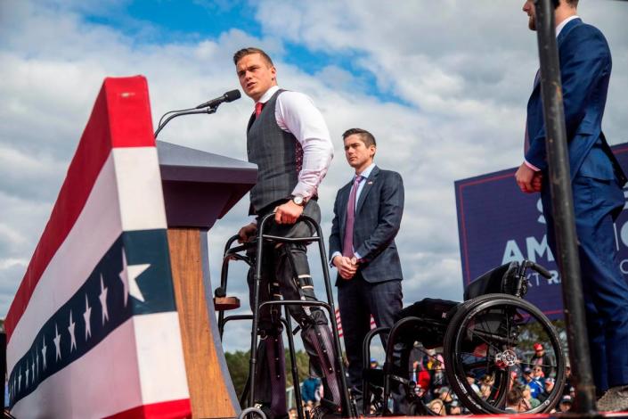 U.S. Rep Madison Cawthorn stands with the aid of a walker during a rally with former President Donald Trump in Selma Saturday, April 9, 2022. Cawthorn was cited for having a gun at a TSA checkpoint at Charlotte Douglas International Airport on Tuesday morning, April 26, 2022, WSOC reported.