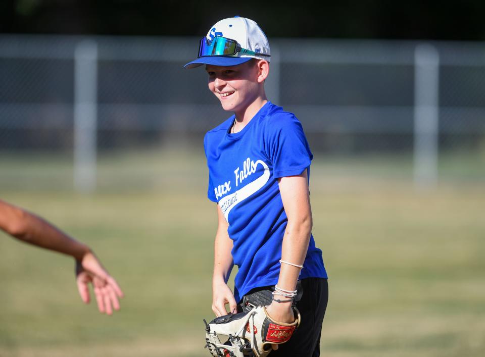 Chase Yde (#9) smiles during Little League practice on Monday, August 1, 2022, at Cherry Rock Park in Sioux Falls.