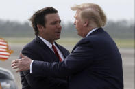 FILE - President Donald Trump shakes hands with Florida Gov. Ron DeSantis as he arrives at Tyndall Air Force Base to view damage from Hurricane Michael, and attend a political rally, May 8, 2019, at Tyndall Air Force Base, Fla. (AP Photo/Evan Vucci, File)