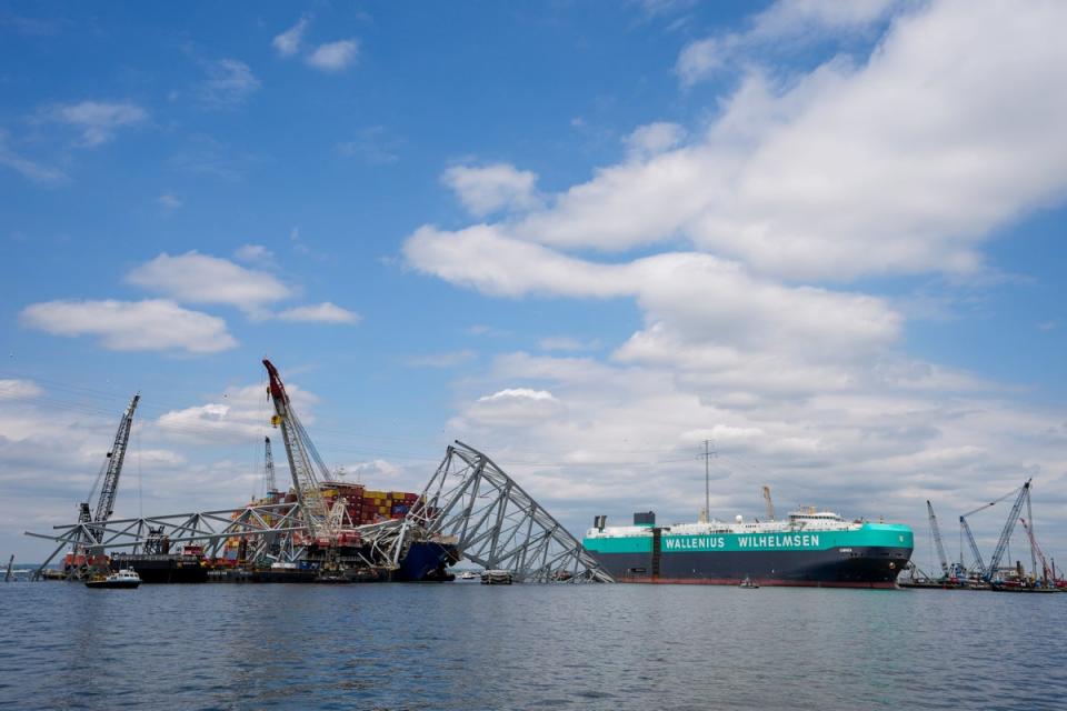 A vessel, center right, moves past the stranded container ship Dali, through a newly opened deep-water channel in Baltimore after being stuck in the harbor since the Francis Scott Key Bridge collapsed (Copyright 2024 The Associated Press. All rights reserved.)