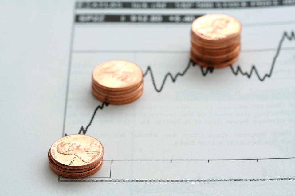 Small stacks of pennies on top of a stock chart.