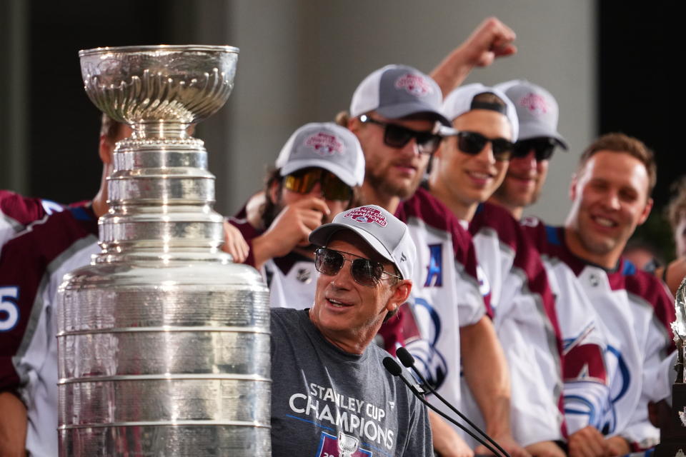 FILE - Colorado Avalanche general manager Joe Sakic looks at the Stanley Cup during a rally for the NHL hockey champions, Thursday, June 30, 2022, in Denver. Joe Sakic adopted a very practical approach to the task of molding the Colorado Avalanche roster that will attempt to repeat as Stanley Cup champions. (AP Photo/Jack Dempsey, File)