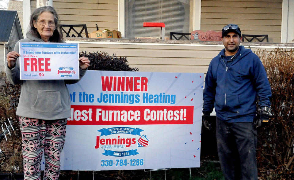 Brenda Deeter of Orrville was the winner of a new gas furnace in Jennings Heating and Cooling's Oldest Furnace Contest. Her furnace was made in1907. With her is installation manager Andy Agraul.