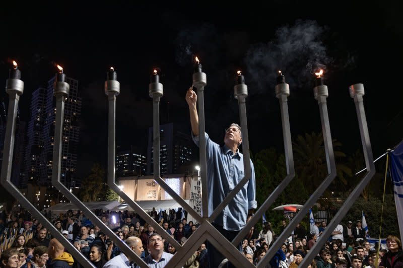 A Hanukkiah candelabra is lit at the end of the Jewish holiday in "Hostages Square" in Tel Aviv, Israel on Wednesday, where families of those being held in Gaza hold memorials and displays calling for their return. Photo by Jim Hollander/UPI