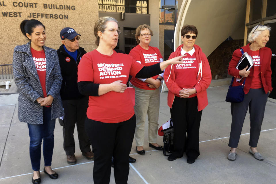 Volunteers with Moms Demand Action, a gun control advocacy group, stand outside a Maricopa County Board of Supervisors meeting in Phoenix on Wednesday, Feb. 26, 2020. Arizona's most populous county on Wednesday joined a growing national movement in which areas are declaring themselves Second Amendment sanctuaries and proclaiming support for gun ownership rights. (AP Photo/Terry Tang)