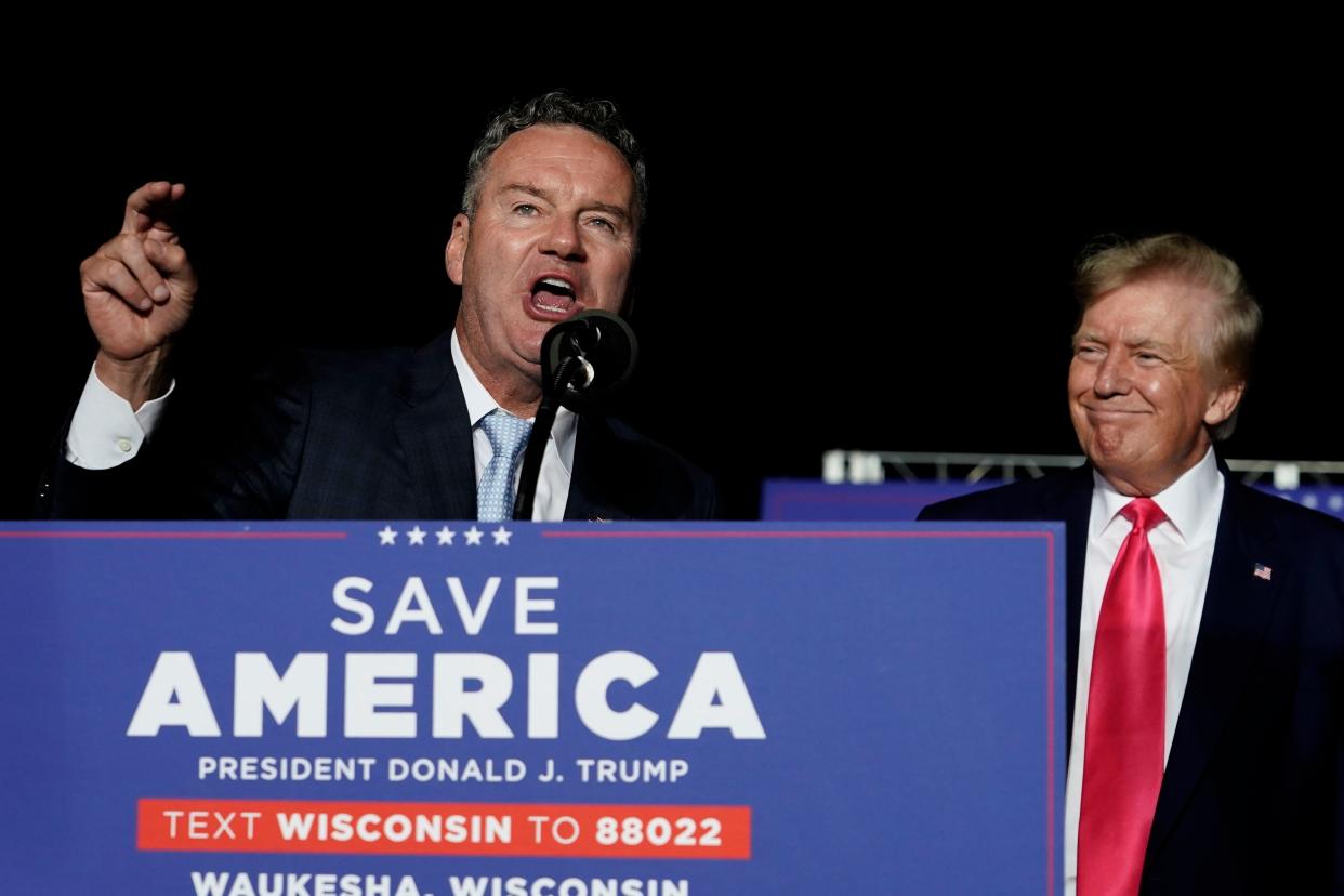 FILE - Wisconsin Republican gubernatorial candidate Tim Michels, left, speaks as former President Donald Trump, right, listens at a rally Aug. 5, 2022, in Waukesha, Wis. 