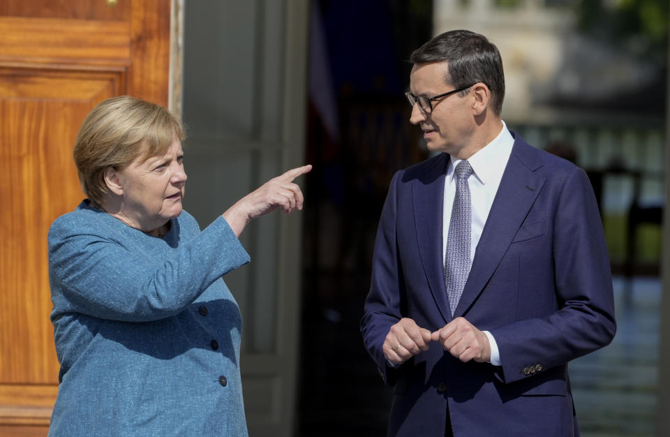 German Chancellor Angela Merkel, left, gestures as she meets Poland's Prime Minister Mateusz Morawiecki in Warsaw, Poland, Saturday, Sept.11, 2021.Merkel is visiting the Polish capital Morawiecki at a time when Poland faces migration pressure on its eastern border with Belarus. (AP Photo/Czarek Sokolowski)