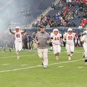 John Wristen leading his team onto the field