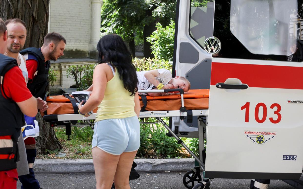 A young boy is carried into an ambulance