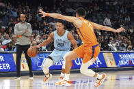 Phoenix' Devin Booker (1) guards Memphis' Desmond Bane (22) in the first half of an NBA basketball game Friday, Nov. 12, 2021, in Memphis, Tenn. (AP Photo/Karen Pulfer Focht)