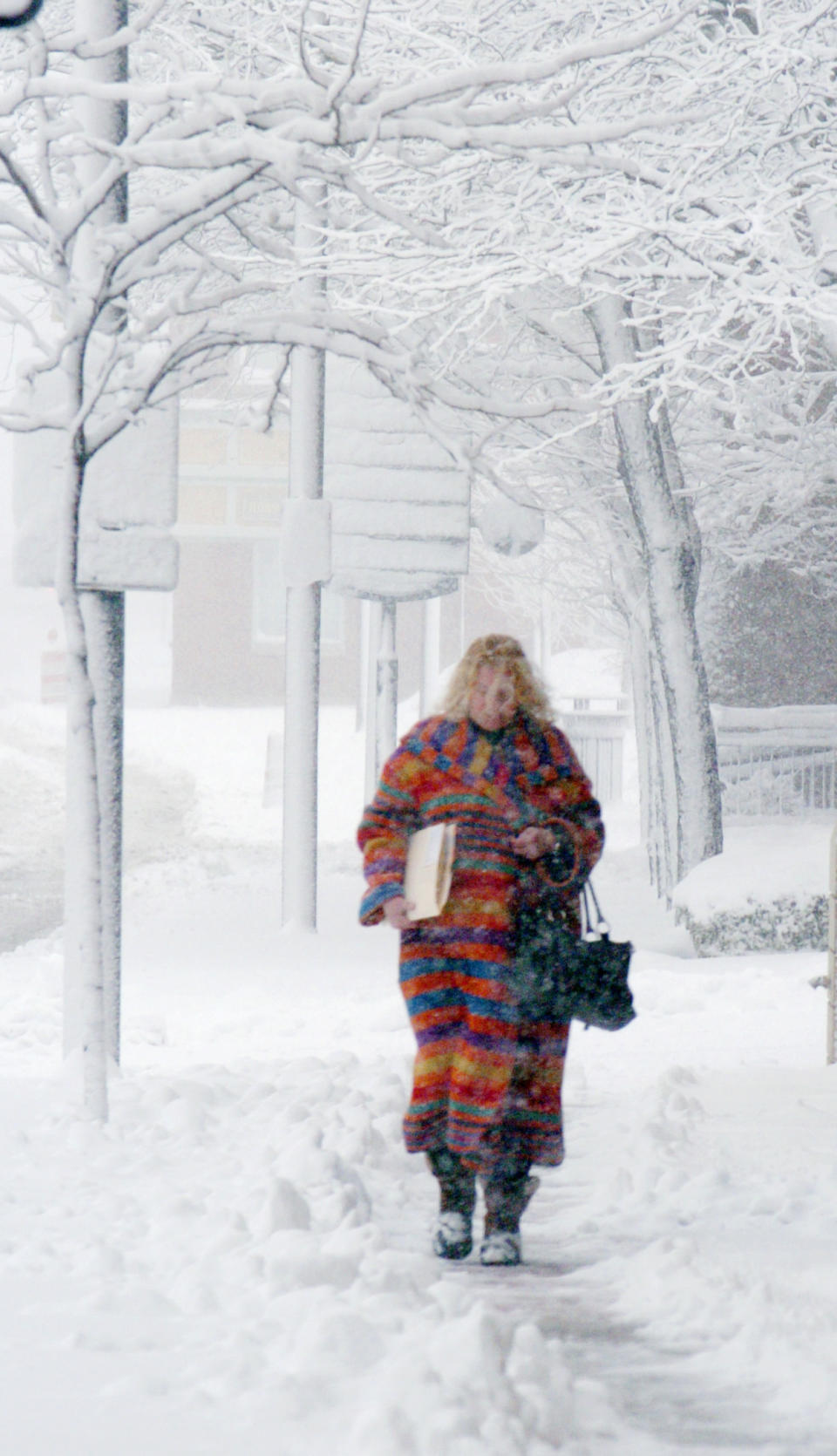 Cathy Christoff makes her way down Main St. from her office to the Allen County Courthouse in Fort Wayne, Ind., Wednesday, March 12, 2014. (AP Photo/The Journal Gazette, Cathie Rowand)