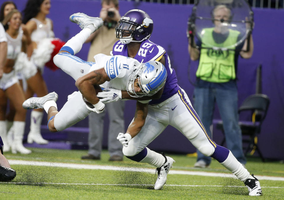 <p>Detroit Lions wide receiver Marvin Jones (11) is tackled by Minnesota Vikings cornerback Xavier Rhodes (29) after making a reception during the first half of an NFL football game, Sunday, Nov. 4, 2018, in Minneapolis. (AP Photo/Bruce Kluckhohn) </p>