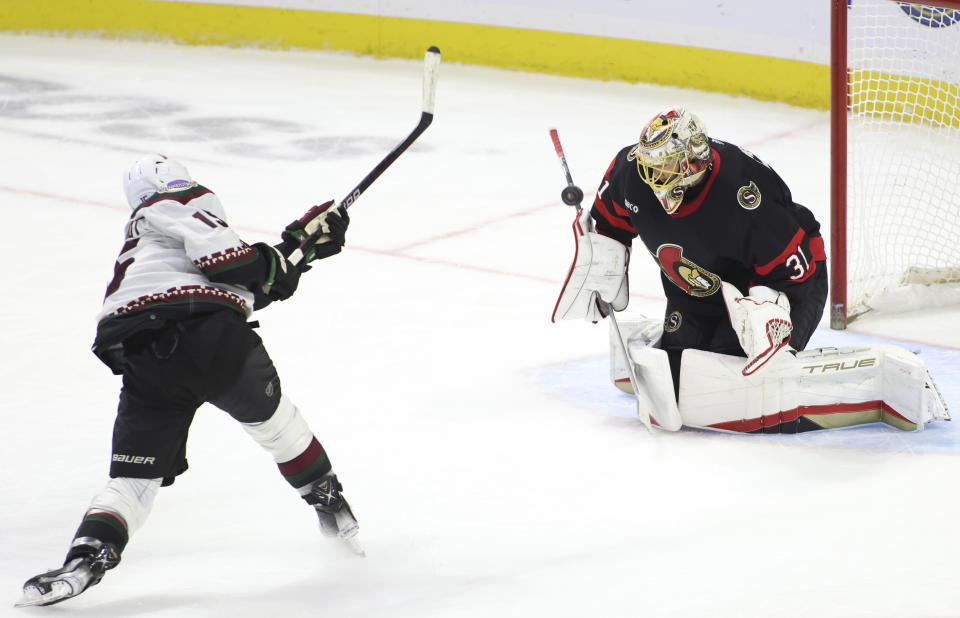 Ottawa Senators goaltender Anton Forsberg (31) makes a save on a shot by Arizona Coyotes' Alex Kerfoot (15) during the third period of an NHL hockey game in Ottawa, Ontario on Friday, March 1, 2024. (Patrick Doyle/The Canadian Press via AP)