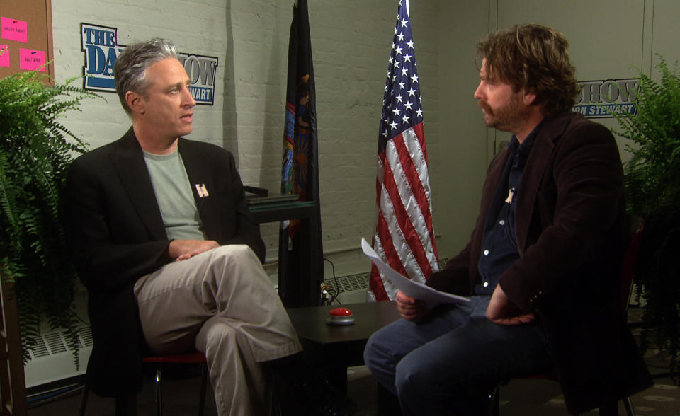 In this undated image from video released by Comedy Central, host Zach Galifianakis, right, talks with Jon Stewart, comedian and host of "The Daily Show with Jon Stewart," from “Between Two Ferns: A Fairytale of New York” a 30-minute special premiering on Sunday, May 6 at 8:30 p.m. EST on Comedy Central. (AP Photo/Comedy Central)