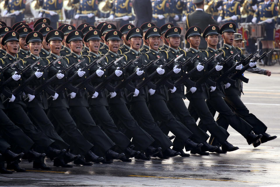 Chinese soldiers rehearse before the start of a parade to mark the 70th anniversary of the founding of the People's Republic of China in Beijing on Tuesday, Oct. 1, 2019. (AP Photo/Ng Han Guan)