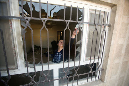 A Christian woman inspects a home in the town of Bartella east of Mosul, Iraq, after it was liberated from Islamic State militants November 23, 2016. REUTERS/Khalid al Mousily