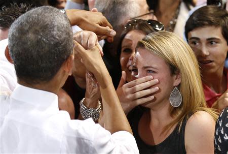 A woman cries while meeting U.S. President Barack Obama at the Coral Reef High School in Miami, Florida, March 7, 2014. REUTERS/Yuri Gripas