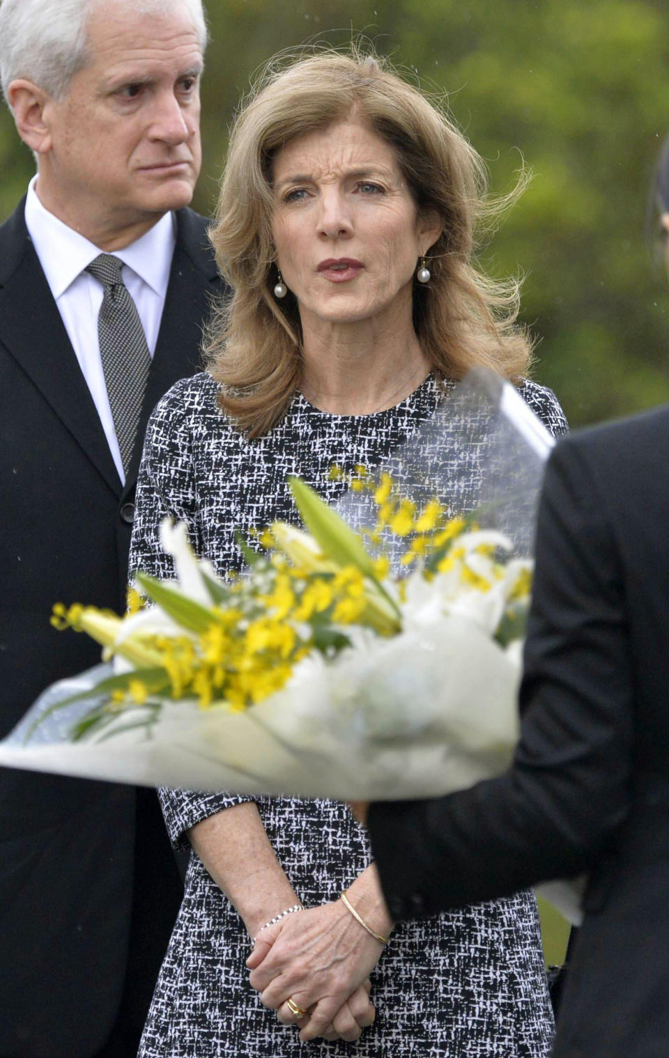 U.S. Ambassador Caroline Kennedy prepares to offer flowers in front of the National War Dead Peace Mausoleum at the Peace Memorial Park in Itoman, Okinawa Wednesday, Feb. 12, 2014. Kennedy,who arrived later Tuesday, is to meet with Okinawan officials and may see the base relocation site during her three-day visit, Kyodo News agency reported. (AP Photo/Kyodo News) JAPAN OUT, MANDATORY CREDIT