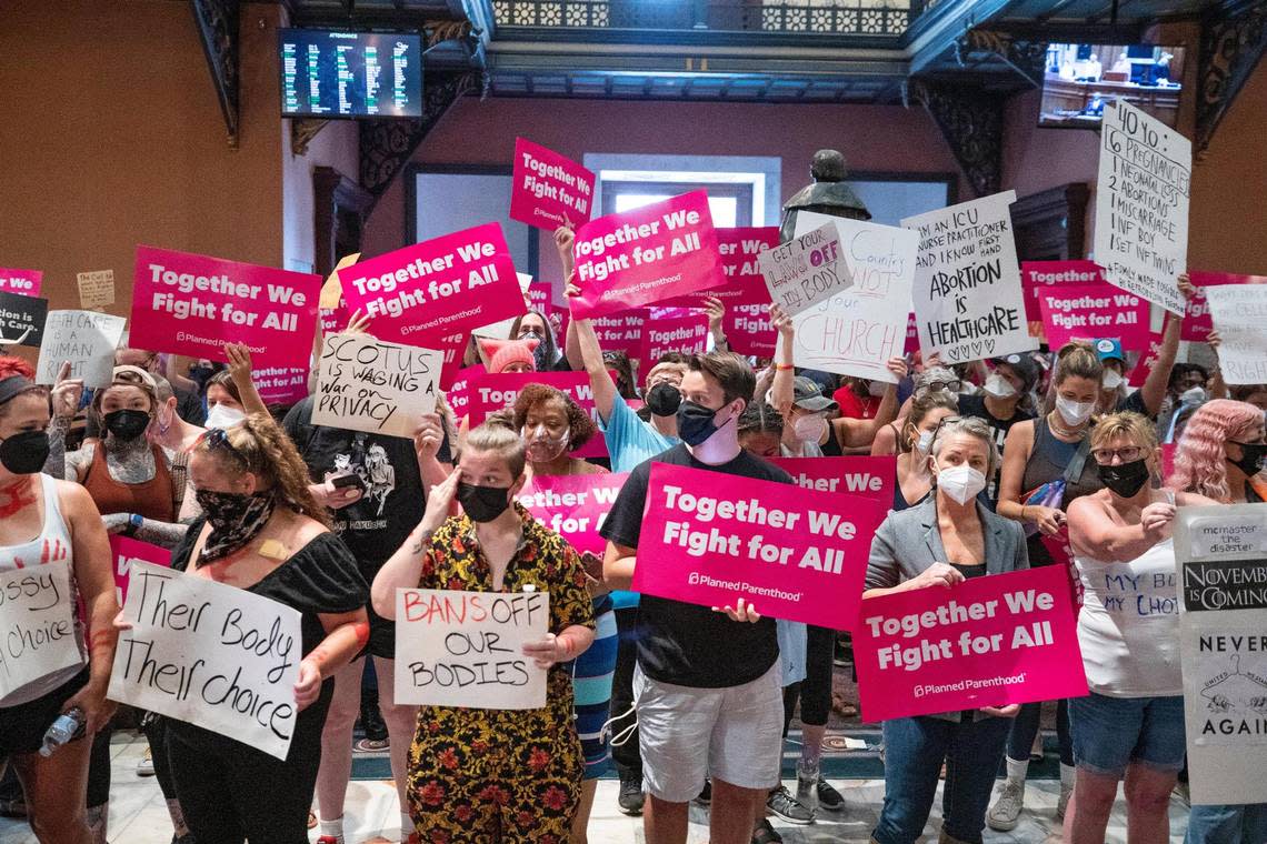 Protestors who support abortion access hold signs in the South Carolina State House lobby on Tuesday, June 28, 2022. While the House was not voting on abortion issues Tuesday, protestors were motivated by last week’s Supreme Court decision letting states decide their own laws on abortion restrictions.