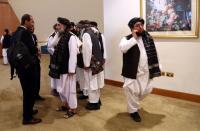 Members of Afghanistan's Taliban delegation are seen ahead of an agreement signing between them and U.S. officials in Doha