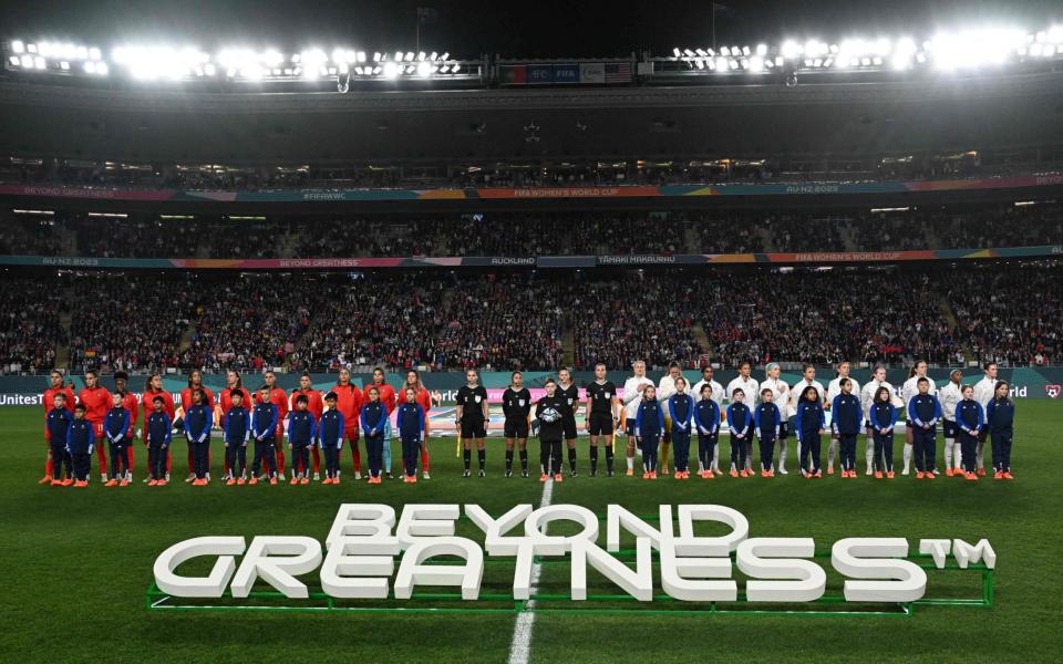 Players listen to national anthems prior to the Australia and New Zealand 2023 Women's World Cup Group E football match between Portugal and the United States at Eden Park in Auckland on August 1, 2023